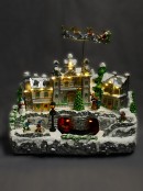 Flying Santa & Reindeer Over Snowy Winter Christmas Village Scene - 38cm