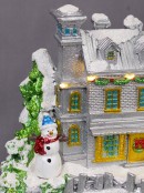Flying Santa & Reindeer Over Snowy Winter Christmas Village Scene - 38cm