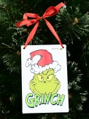 Smirking Grinch Face Metal Christmas Hanging Sign Plaque - 15cm